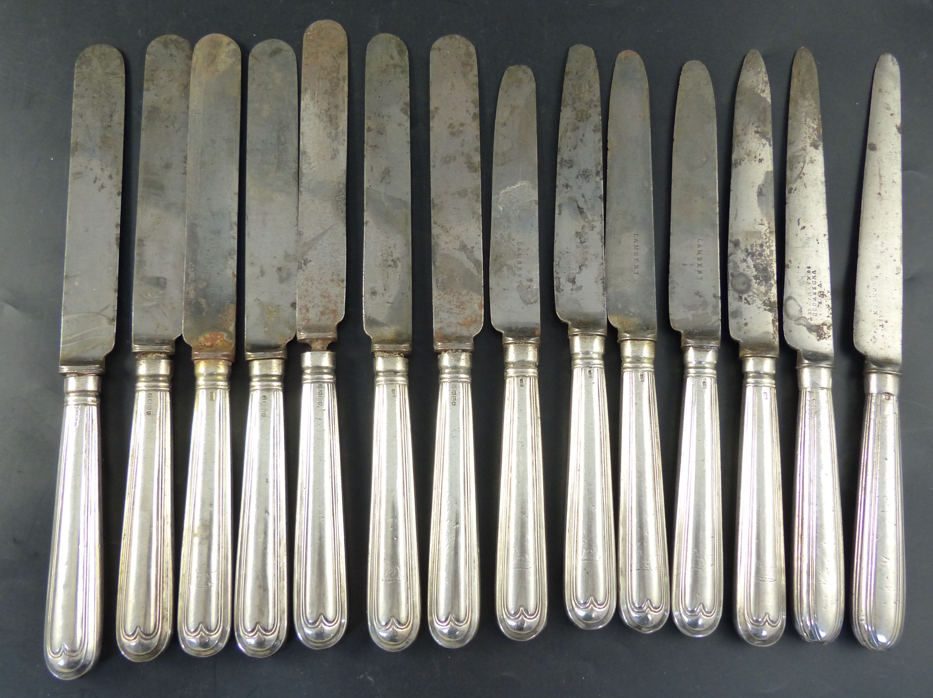 A set of twelve George IV silver handled thread pattern table knives,